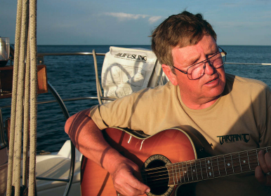 A picture of a man playing the guitar