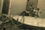 Dad, Boo Boo, and I pose with the dinghy he built in the living room.