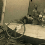 Dad, Boo Boo, and I pose with the dinghy he built in the living room.