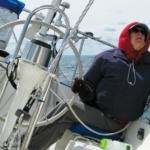 Is it that watching telltales gives her a stiff neck or that bundling up to steer the cold Lake Superior breezes — over a life jacket to boot — makes her feel like the Michelin Man? Whatever the reason, Karen doesn’t take well to the helm.