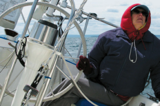 Is it that watching telltales gives her a stiff neck or that bundling up to steer the cold Lake Superior breezes — over a life jacket to boot — makes her feel like the Michelin Man? Whatever the reason, Karen doesn’t take well to the helm.