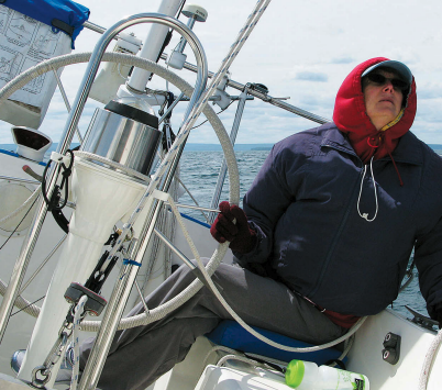 Is it that watching telltales gives her a stiff neck or that bundling up to steer the cold Lake Superior breezes — over a life jacket to boot — makes her feel like the Michelin Man? Whatever the reason, Karen doesn’t take well to the helm.