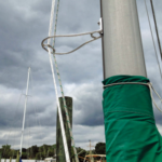 Tom’s halyards clip into a carabiner welded into his Halyard Handler.