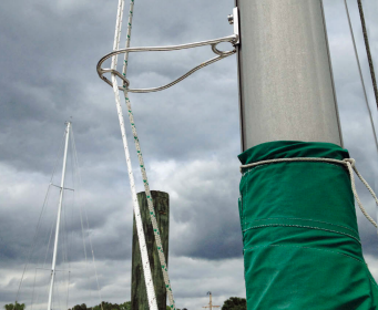 Tom’s halyards clip into a carabiner welded into his Halyard Handler.