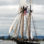 With a sparred length of 122 feet and a mast height of 94 feet, the privateer Lynx, a War of 1812 replica ship, makes Karen’s blue 30-footer at left look small. For more, see privateerlynx.com.
