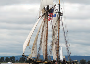 With a sparred length of 122 feet and a mast height of 94 feet, the privateer Lynx, a War of 1812 replica ship, makes Karen’s blue 30-footer at left look small. For more, see privateerlynx.com.