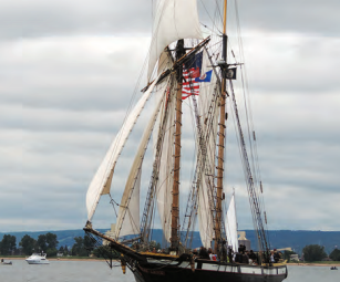 With a sparred length of 122 feet and a mast height of 94 feet, the privateer Lynx, a War of 1812 replica ship, makes Karen’s blue 30-footer at left look small. For more, see privateerlynx.com.