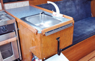 The board is attached by a hinge to the counter’s fiddle rail, which provides the needed offset for the drop-leaf support bracket.