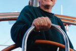 A man at a boat helm