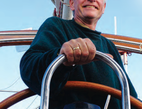 A man at a boat helm