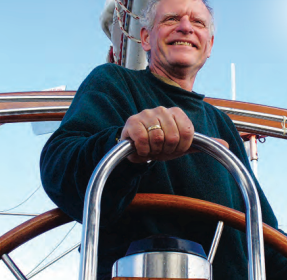 A man at a boat helm