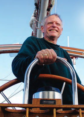 A man at a boat helm