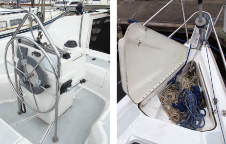The mainsheet tackle connects to a short traveler mounted on the custom steering pedestal, at left. On the foredeck, an anchor locker with a hinged cover holds a modestly sized anchor and rode, at right.