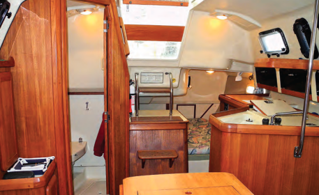 Even with the head adjacent to the companionway, the galley and aft berth area still appears spacious. The cook has plenty of room to work and can commandeer the top of the engine box if necessary.
