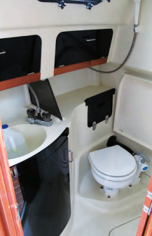 A fold-down seat is handy in the head and aids cleanup by sheltering the toilet from shower water.
