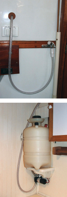 The shower nozzle lives in the cockpit, at top, on the other side of the bulkhead from the tank in the head compartment, above.