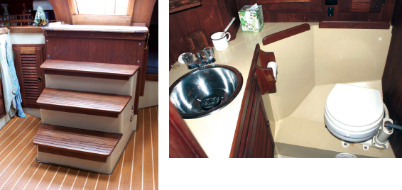Instead of a ladder, the companionway has stairs, far left. The engine is behind them. The head, at left, is a molded fiberglass module with adequate storage and a sink. The holding tank for waste is small at 6 gallons.