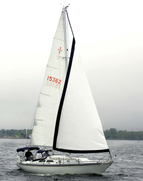 Jack and Anneke Wolf sail their Islander 36, Trillium, on Muskegon Lake, Michigan. The sleek lines of this 40-year-old design have lost none of their appeal.