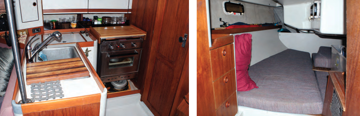 The well-thought-out galley has a cutting board over one of the twin sinks and plenty of stowage in shelves and cabinets outboard, at left. The door in the galley leads to the aft cabin, at right. Although it’s mostly tucked under the cockpit, it has a little standing room at the forward end and two ports for ventilation.