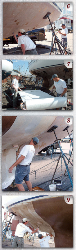 Once they had finished planing the hull, the team began spot filling and fairing individual spots to create a smooth and fair structure for relamination (PHOTO 6). On the day of layup, they set up a temporary workbench of plywood and sawhorses where the cloth could be rolled out and cut to approximate size (PHOTO 7). Working in sections along the hull, they applied a light resin coating. Once the resin became tacky, they carefully placed the new cloth in position (PHOTO 8), and followed up by thoroughly wetting out the cloth (PHOTO 9).