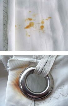 One of the more visible causes of chemical damage to sails is rust, which might arise from stowing a wet sail, upper image, or from corrosion of sail hardware, above.
