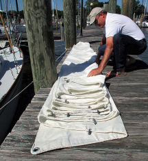 John, or in this case his brother Charlie, folds jibs on the dock if it isn’t too windy, above.