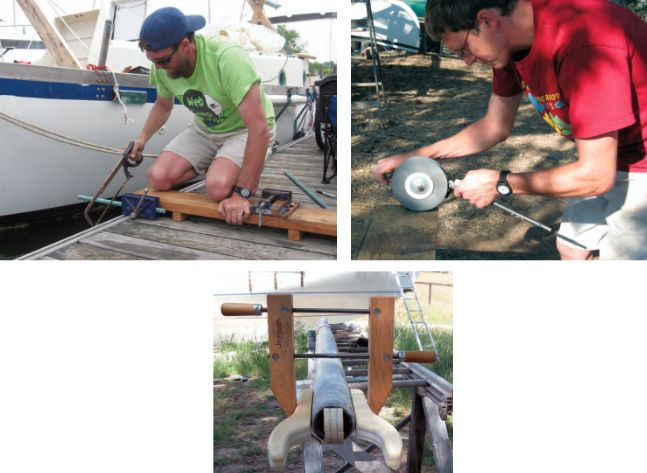 Ben fitted a woodworking vise and a drill-press vise to his portable workbench, at left. The two wooden feet underneath fit securely into Ganymede’s foc’s’le hatch coamings when Ben has a project he can work on when on board. Ben sharpens a long drill bit on his hand-powered grinder, at right. This one is made by the Prairie Tool company and costs about $15. It attaches to the table with a screw clamp. A big wooden clamp holds the boom jaws to the fiberglass boom, below, until they can be glassed firmly in place.