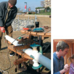 With the big wooden clamp holding Ganymede’s bowsprit firmly in place, at left, Ben modifies the cranse iron. Antigone helps her father drive a screw with his ratcheting hand-brace, below, one of the most useful items in the cruiser’s box of tools that don’t need electricity.