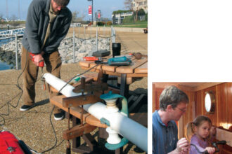 With the big wooden clamp holding Ganymede’s bowsprit firmly in place, at left, Ben modifies the cranse iron. Antigone helps her father drive a screw with his ratcheting hand-brace, below, one of the most useful items in the cruiser’s box of tools that don’t need electricity.