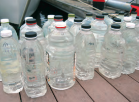The Zartmans store water in plastic bottles and containers and mark the dates they are filled.