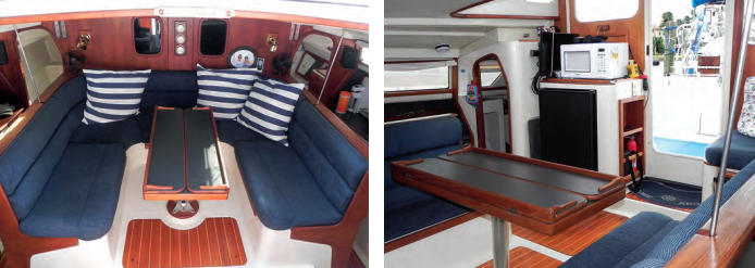Spanning the width of the bridge deck, the saloon is generously roomy for any 32-foot boat, at left, and the sense of space is further enhanced by the open areas in the hulls abreast of the saloon. The bridge deck also has room next to the companionway for the three-way refrigerator and microwave, at right.