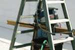 Perry’s outboard-motor test rig uses a few items from the garage. Hanging the motor inside the stepladder ensures the rig is stable.