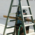 Perry’s outboard-motor test rig uses a few items from the garage. Hanging the motor inside the stepladder ensures the rig is stable.