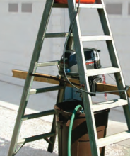 Perry’s outboard-motor test rig uses a few items from the garage. Hanging the motor inside the stepladder ensures the rig is stable.