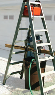 Perry’s outboard-motor test rig uses a few items from the garage. Hanging the motor inside the stepladder ensures the rig is stable.