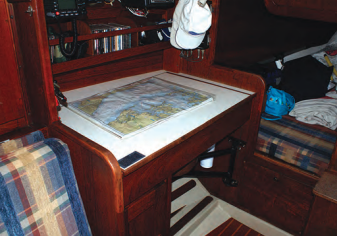 The navigation station is large enough that charts can be unfolded and laid out. It has a useful bookshelf and also has space for mounting a few instruments. A swing-out seat stows out of the way when not in use. The quarter berth makes a cosy sleeping cubby or a handy storage area.