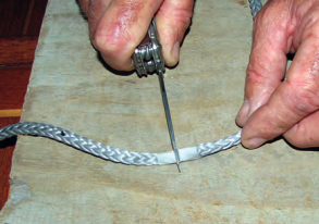 Dyneema is very tough. A very sharp knife is needed to cut it and the blade will need to be sharpened often. A wrap of tape holds the strands together.