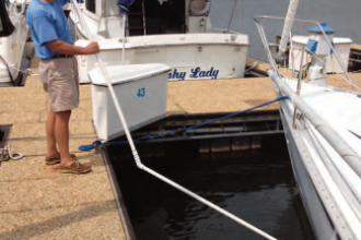 Ferman demonstrates how he can clean his boat’s bottom while she’s in her slip.