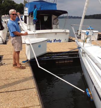 Ferman demonstrates how he can clean his boat’s bottom while she’s in her slip.