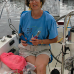 A woman holding pliers on a boat