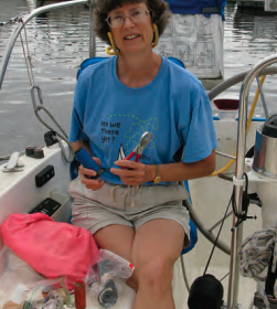 A woman holding pliers on a boat