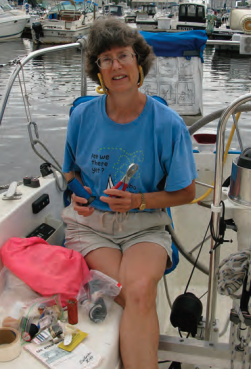 A woman holding pliers on a boat