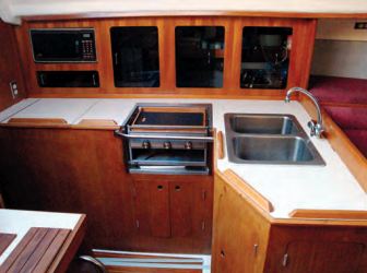 There’s enough counter space in the L-shaped galley, above, for reasonably convenient food preparation. The two-burner CNG cooktop has a broiler and a microwave does duty as an oven when shorepower is available.