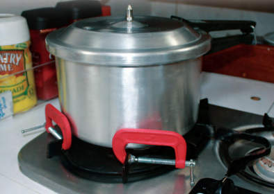 When a pot needs restraining on a stovetop that has no fiddles, a couple of C-clamps can save the stew.
