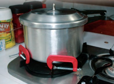 When a pot needs restraining on a stovetop that has no fiddles, a couple of C-clamps can save the stew.