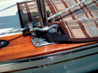 One mat protects the varnished cap rail and gives the dogs traction on the sidedeck. Velcro straps secure it to the stanchion bases.