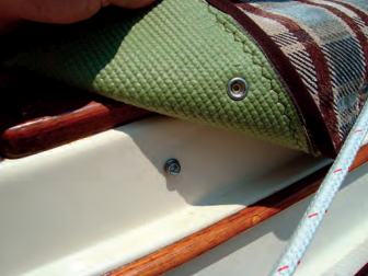 Stephen used the existing Bimini-strap snaps to attach the upper mat to the coaming. The binding tape is a tidy finishing touch.