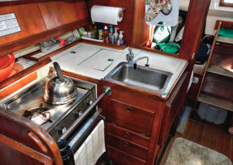 The galley is tight but has all the essentials — and lots of drawers!