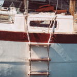 Richard transformed a plank retrieved from the harbor and a couple of lengths of three-strand rope into a practical and effective ladder.