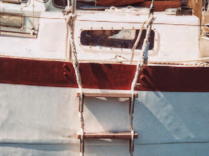 Richard transformed a plank retrieved from the harbor and a couple of lengths of three-strand rope into a practical and effective ladder.